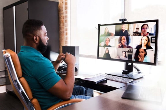 Man at his desk taking part in a video conference