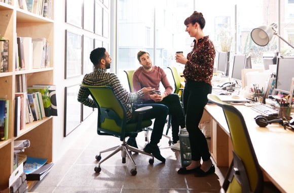 Three colleagues having a friendly discussion