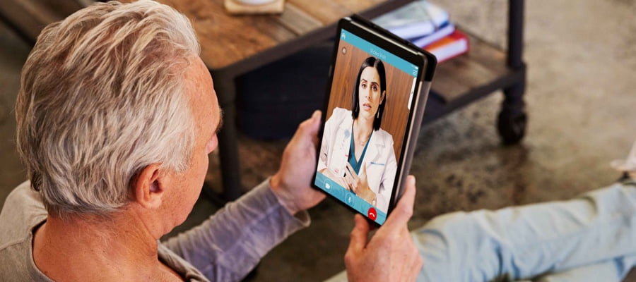 Man doing a video consultation with his doctor using a tablet