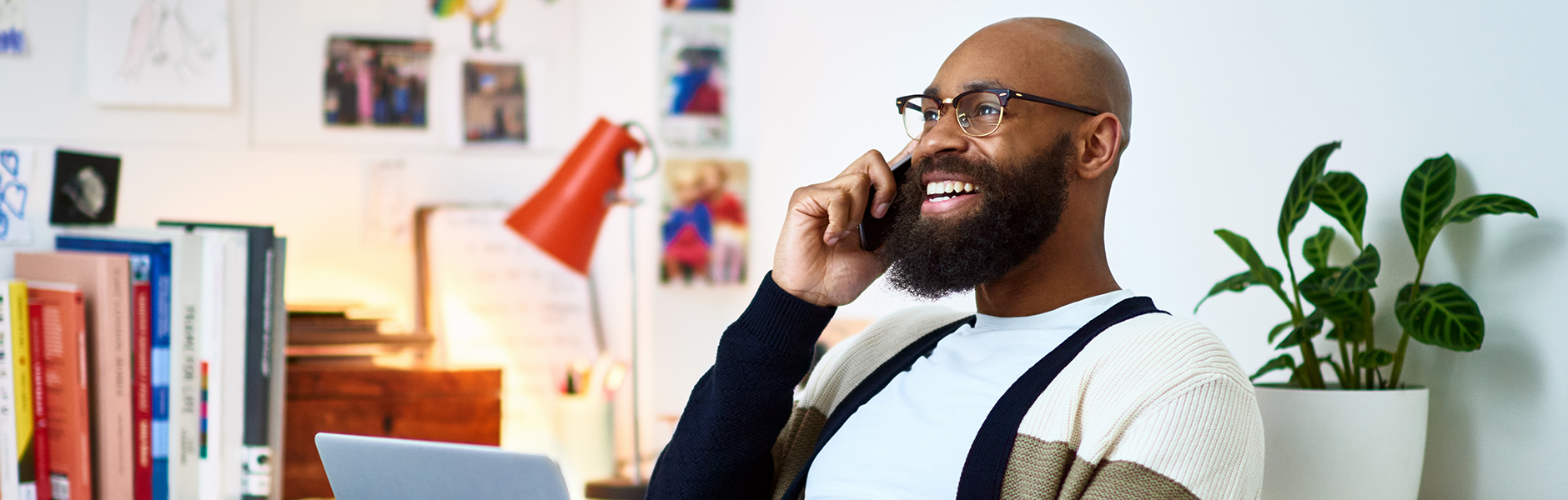 Person talking on a mobile phone from their home office