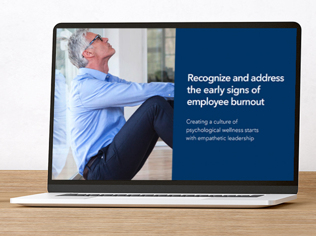 Laptop showing a person leaning against an office wall with adjacent text which reads Recognize and address the early signs of employee burnout